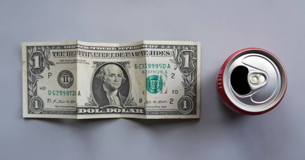 dollar bill and soda can