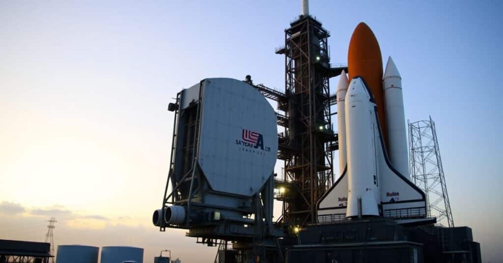 A Space Shuttle, measuring approximately 100 feet, ready for its launch