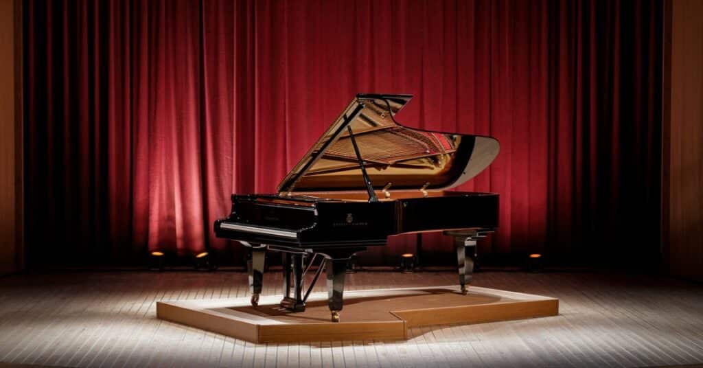 A close up image of a grand piano on the stage, illustrating its elegance and size.