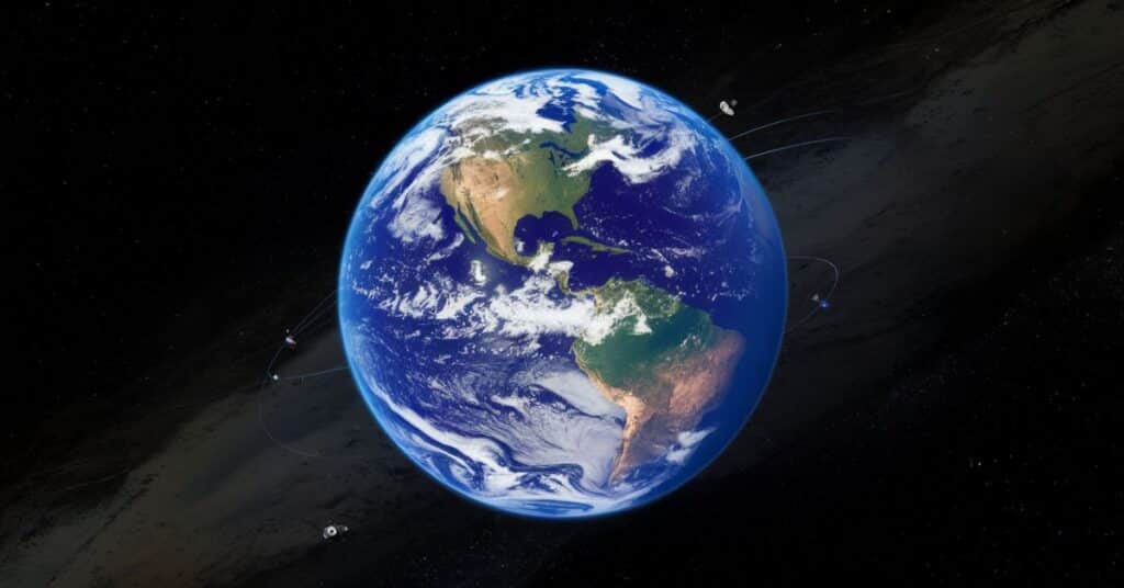 A medium shot of a beautiful image of the earth from space. The earth is a vibrant blue and green sphere with white clouds and a thin blue atmosphere. The earth is surrounded by a dark void of space. There are multiple small satellites orbiting the earth.