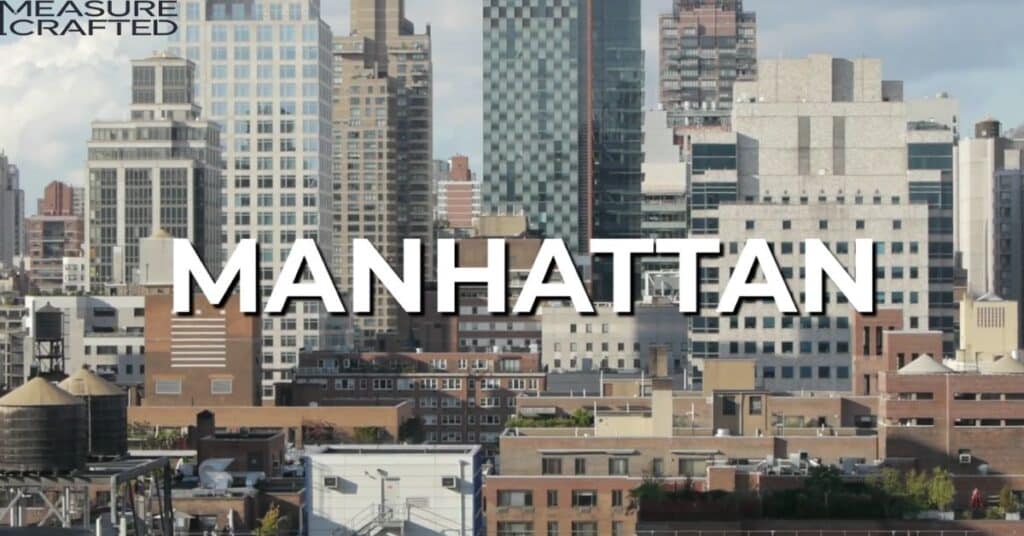 A picture of one of the boroughs of New York City, known as Manhattan. Manhattan is written on the picture and behind the text, there are few buildings od Manhattan.