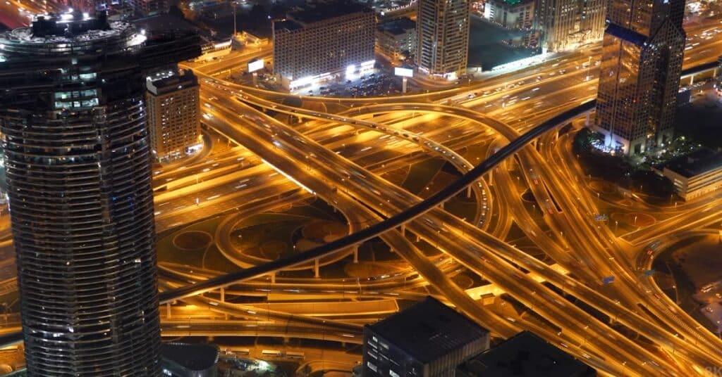 Ariel view of the roads in New York City. All the roads aer shining brights. Few cars are on the road.